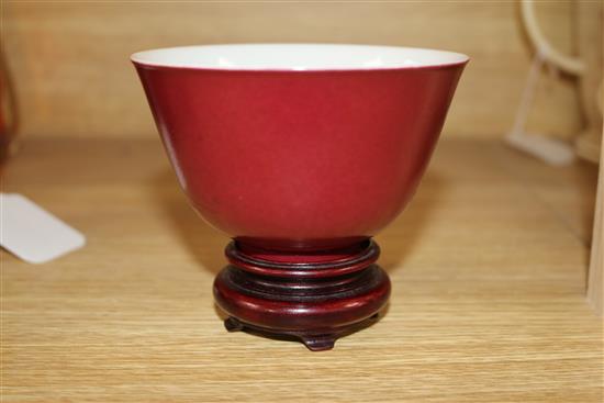 A Chinese ruby ground cup, wood stand Bowl 6.5cms H